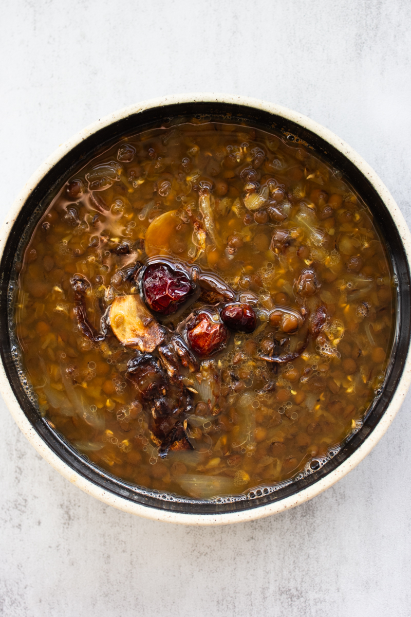 Kali dal with tadka in a serving bowl